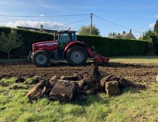 A tractor on a dirt field

Description automatically generated